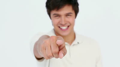 Stock footage man pointing at the camera against white background